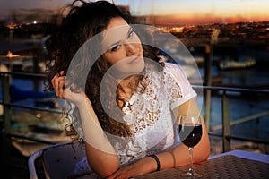 Young brunette girl with a glass of wine