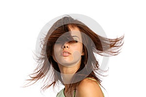 Young brunette girl with a hairdress in movement