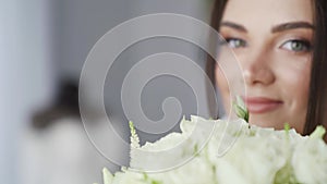 Young brunette girl looking at the camera. Luxury fashion bride in a white dress