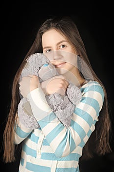Young brunette girl with teddy bear