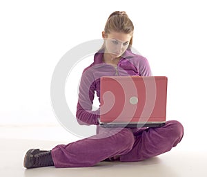 Young brunette girl using laptop