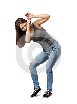 Young brunette girl wearing casual jeans and t-shirt protecting herself with hands isolated on white background