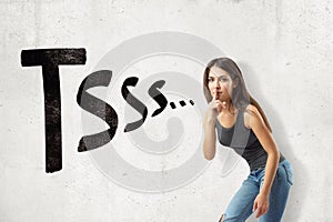 Young brunette girl wearing casual jeans and t-shirt showing silent gesture with TSSS sign isolated on white background