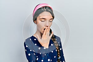 Young brunette girl wearing elegant look bored yawning tired covering mouth with hand