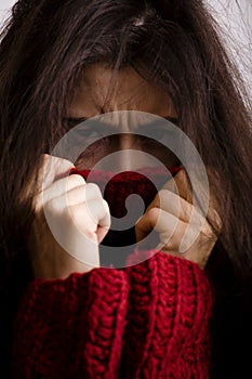 Young brunette gloomy woman in sweater all over