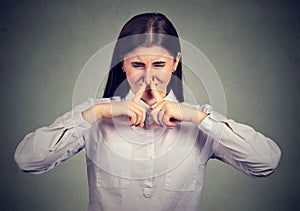 Woman suffering from bad smell photo