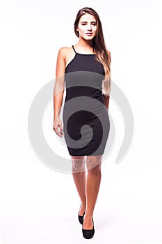 Young brunette lady in black dress posing on grey