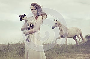 Young brunette lady holding little lamb