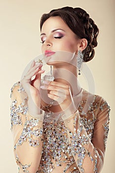 Young Brunette with Perfume Bottle. Fragrance