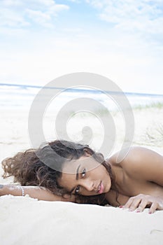 Young Brunette resting on beach.