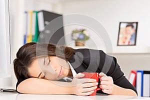 Young brunette sleeping at working time.