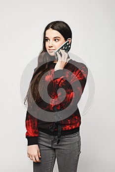 Young brunette teen girl talking on the phone