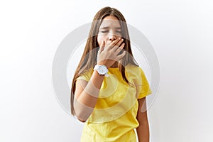 Young brunette teenager standing together over isolated background bored yawning tired covering mouth with hand