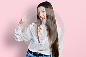 Young brunette teenager wearing business white shirt smiling doing phone gesture with hand and fingers like talking on the