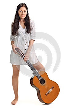 Young brunette in white chemise with guitar photo