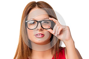 Young brunette woman adjusts glasses