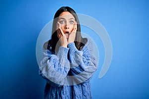 Young brunette woman with blue eyes wearing casual turtleneck sweater afraid and shocked, surprise and amazed expression with