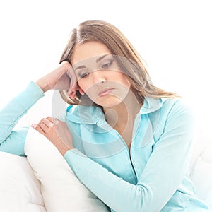 A young brunette woman in a blue sweater feeling sad