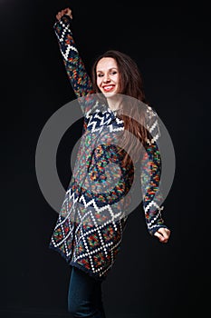 Young brunette woman in bright sweater smiling