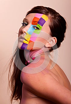 Young brunette woman with colorful makeup