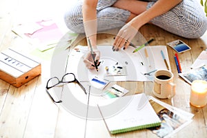 Young brunette woman creating her Feng Shui wish map using scissors