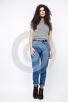 Young brunette woman with curly hairstyle in bright casual clothers isolated on white background gesturing happy smiling