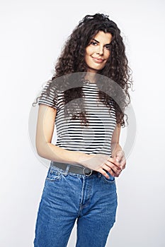 Young brunette woman with curly hairstyle in bright casual clothers isolated on white background gesturing happy smiling