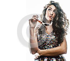 Young brunette woman with curly hairstyle in fancy glamur dress