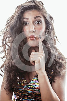 Young brunette woman with curly hairstyle in fancy glamur dress isolated on white background gesturing emotional