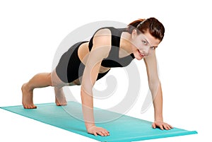 Young brunette woman doing push ups