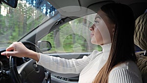 Young brunette woman driving a car