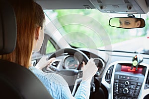 Young brunette woman driving a car