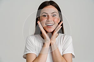 Young brunette woman expressing surprise at camera