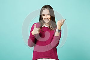 Young brunette woman girl in casual clothes posing isolated on blue green turquoise wall background studio portrait