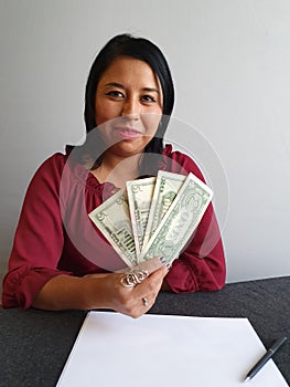 young brunette woman grabbing and showing American dollar money