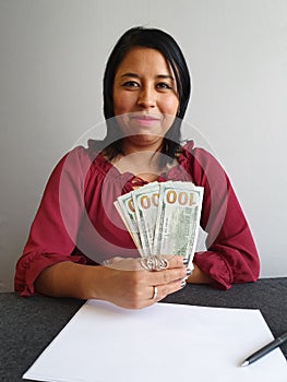 young brunette woman grabbing and showing American dollar money