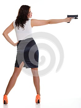 Young brunette woman with gun isolated on white