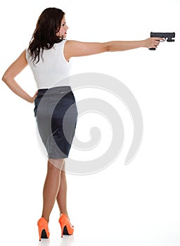 Young brunette woman with gun isolated on white