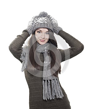 Young brunette woman in hat, gloves and scarf on white