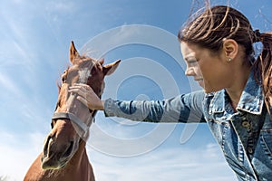Young brunette woman and her horse