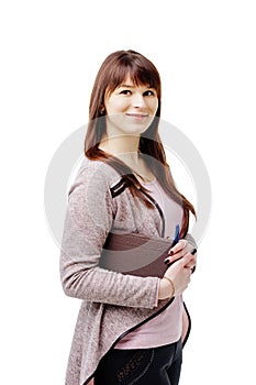 Young brunette woman holding a notebook and pen on white isolated background