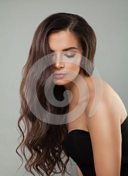 Young brunette woman with long brown curly hair, natural beauty