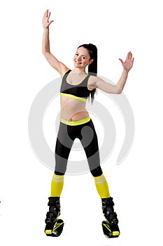 Young brunette woman with long hair training in a kangoo jumps s