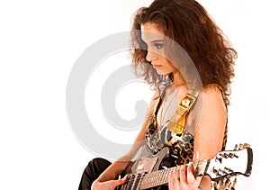 A young brunette woman playing an electric guitar