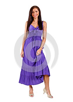 Young brunette woman in purple / violet dress isolated on white background