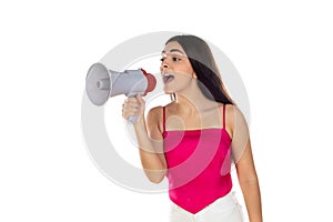 Young brunette woman shouting with a megaphone