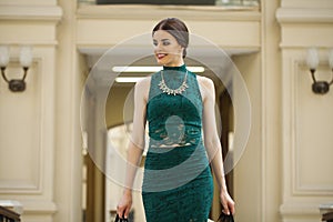 Young brunette woman with some shopping bags in the mall