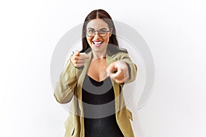 Young brunette woman standing over isolated background pointing to you and the camera with fingers, smiling positive and cheerful