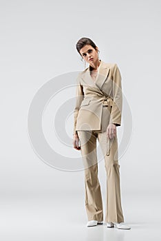 young brunette woman in stylish pantsuit