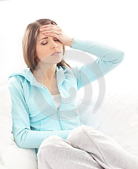 A young brunette woman suffering from a headache
